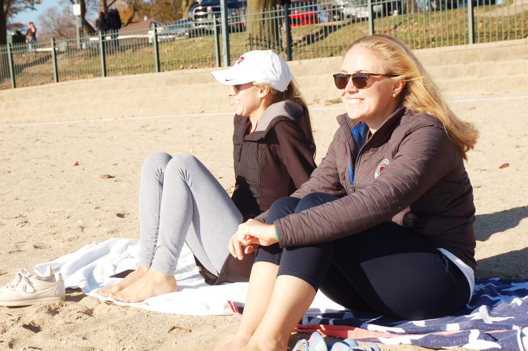 Friends watch kiteboarders on Riviera Beach